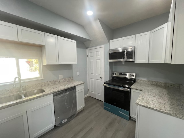 kitchen with sink, white cabinets, light hardwood / wood-style floors, and appliances with stainless steel finishes