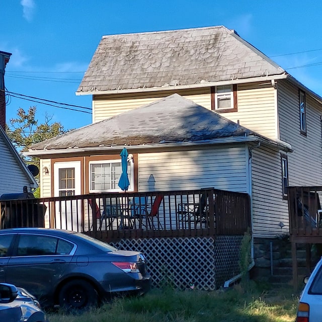 rear view of property with covered porch