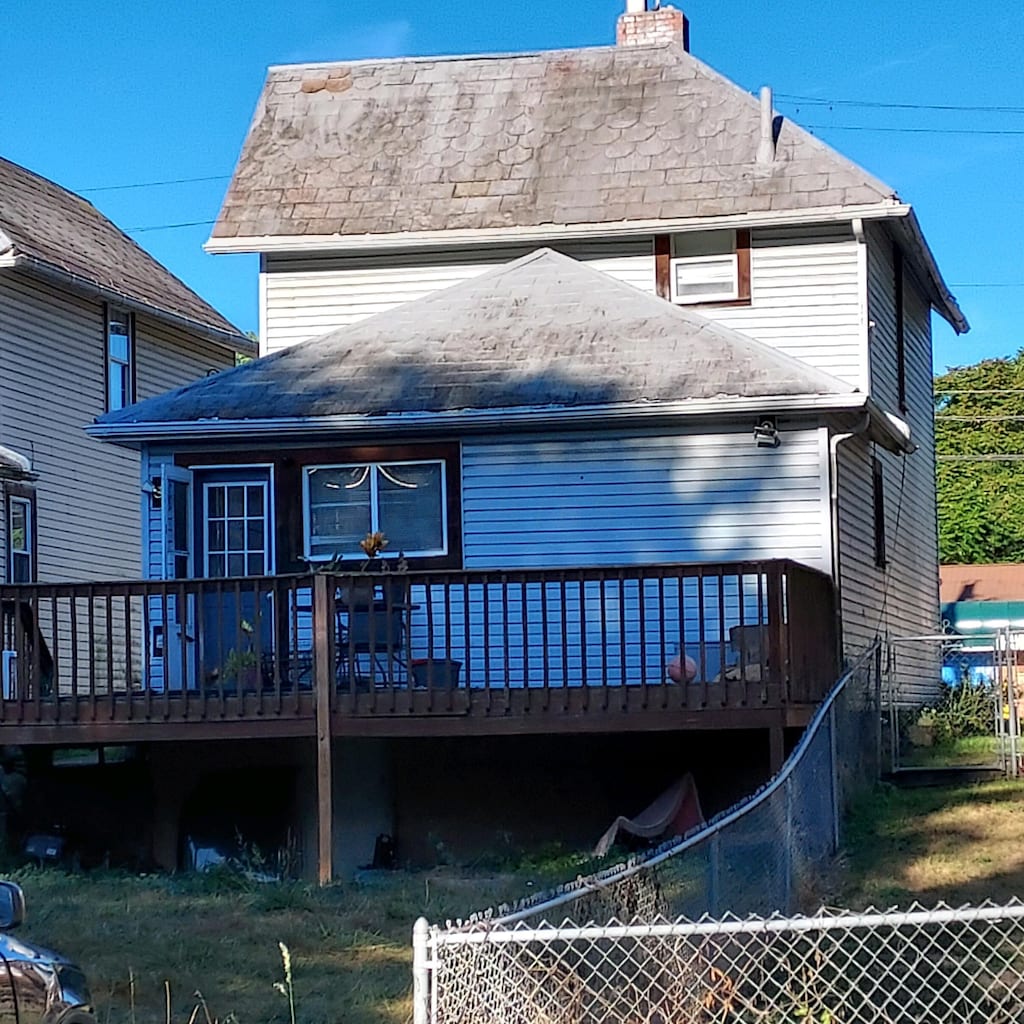 rear view of property featuring a deck