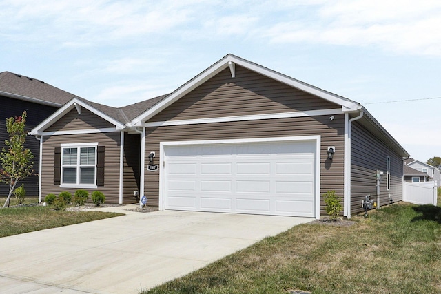 ranch-style house featuring a garage and a front lawn