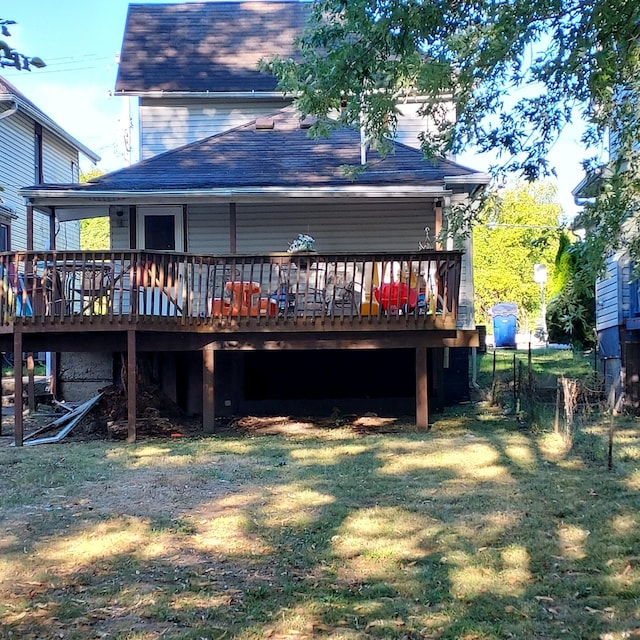 back of property with a lawn and a deck