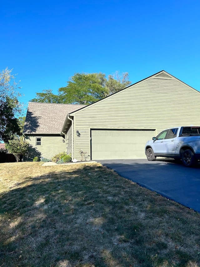 view of home's exterior featuring a lawn and a garage