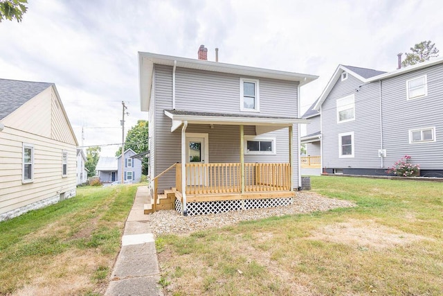 rear view of property featuring a yard