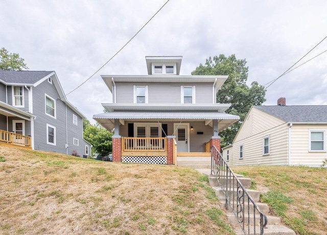 view of front of home with a porch and a front yard