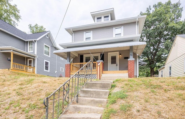 view of front of property with a porch and a front lawn