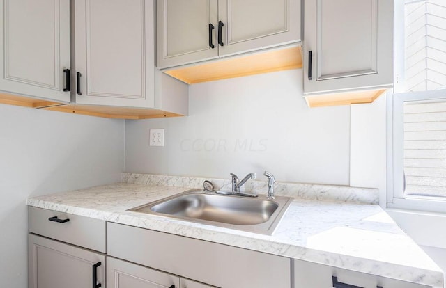 kitchen featuring gray cabinets and sink