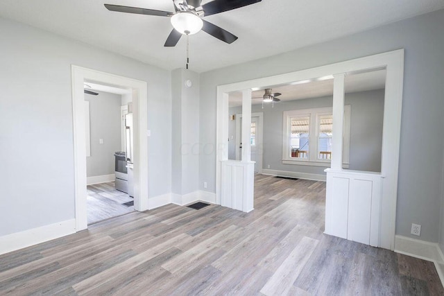 empty room featuring light hardwood / wood-style flooring and ceiling fan