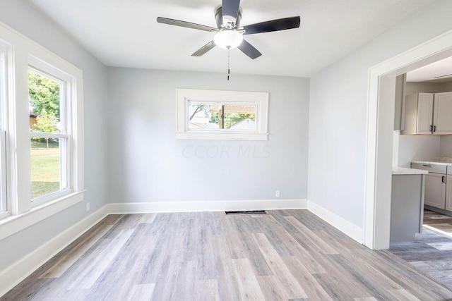 unfurnished dining area featuring ceiling fan and light hardwood / wood-style floors