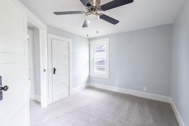 empty room with light colored carpet and ceiling fan