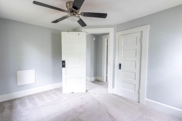 unfurnished bedroom featuring light colored carpet and ceiling fan