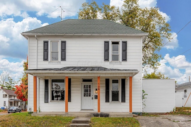 view of front of house featuring covered porch and a front lawn