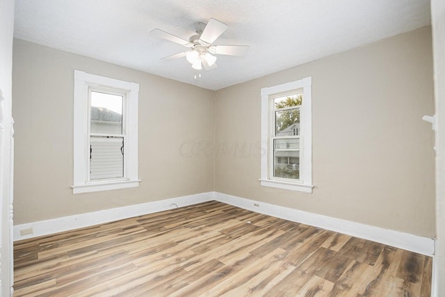 unfurnished room featuring hardwood / wood-style floors, a textured ceiling, and ceiling fan