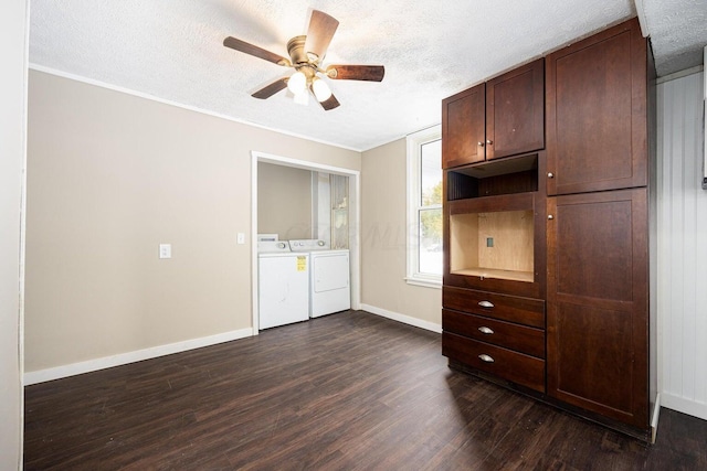 unfurnished bedroom with a textured ceiling, ceiling fan, crown molding, dark wood-type flooring, and washing machine and dryer