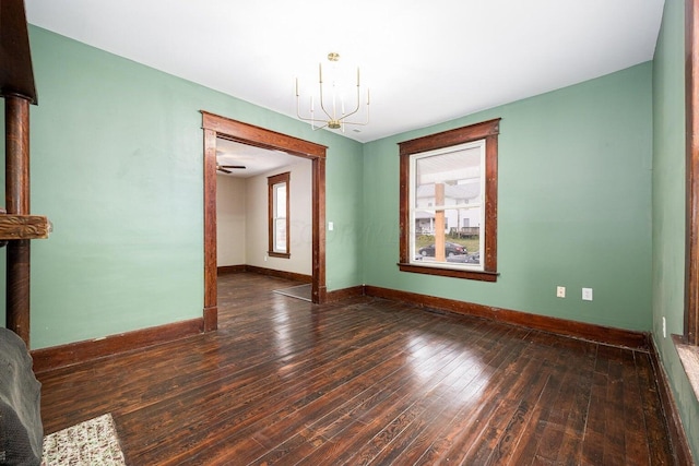 interior space featuring dark hardwood / wood-style floors and ceiling fan with notable chandelier