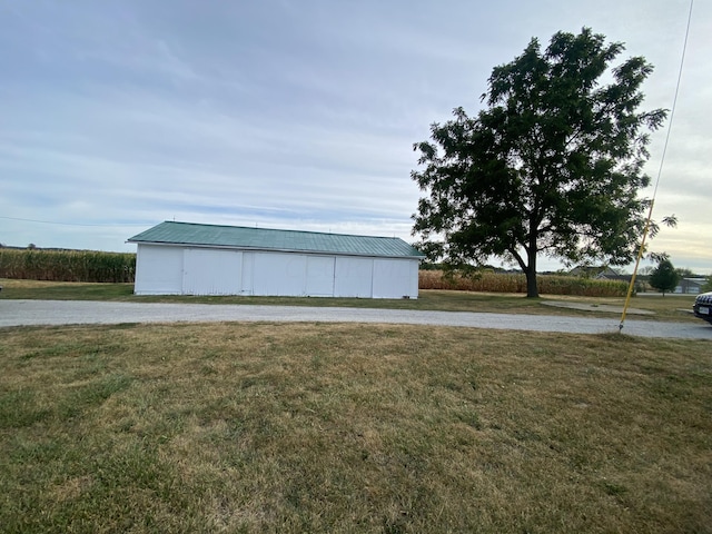 view of outbuilding featuring a lawn