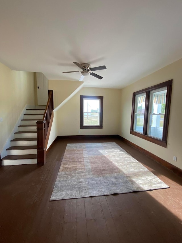 additional living space featuring ceiling fan and dark hardwood / wood-style flooring