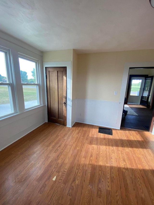 empty room with light hardwood / wood-style flooring