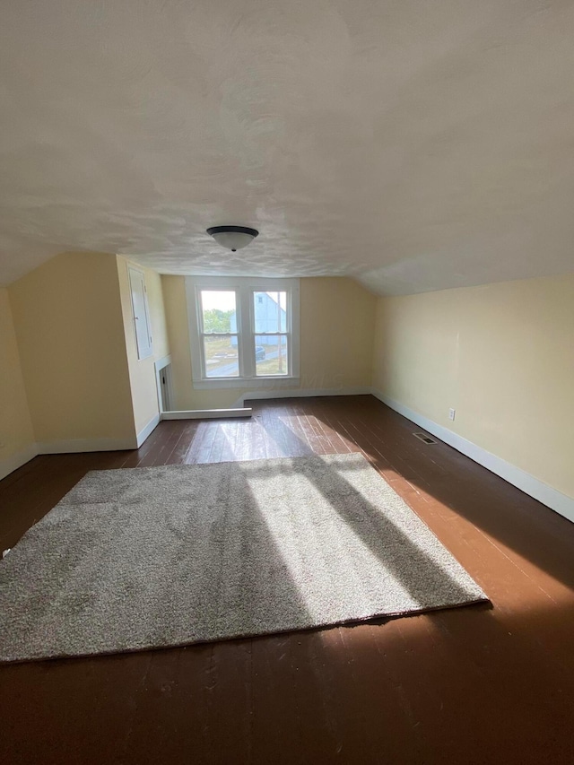 additional living space with dark hardwood / wood-style floors