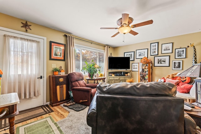 living room featuring ceiling fan and hardwood / wood-style floors