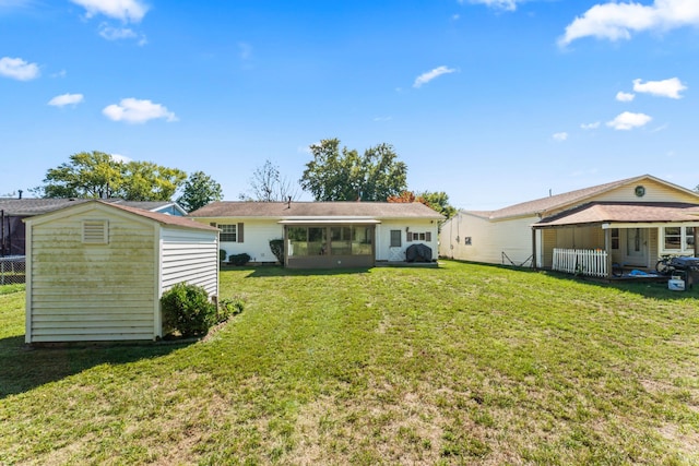 back of house featuring a yard and a storage shed