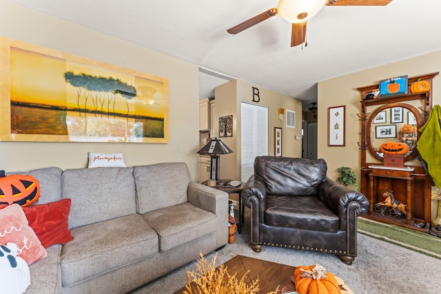 living room featuring carpet floors and ceiling fan