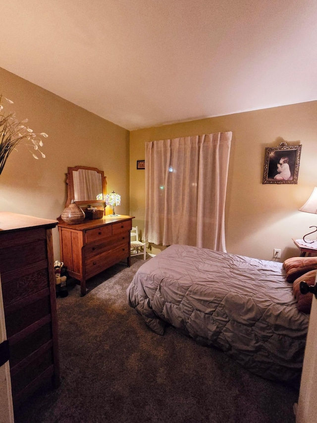 bedroom with dark colored carpet