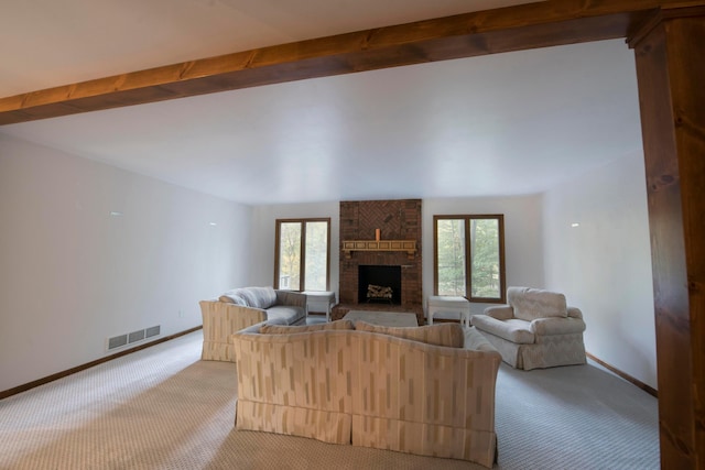 unfurnished living room featuring light carpet, a wealth of natural light, and a fireplace