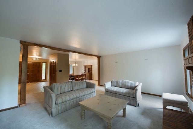 carpeted living room with a chandelier