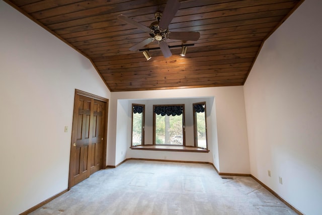 carpeted spare room featuring lofted ceiling, ceiling fan, and wooden ceiling