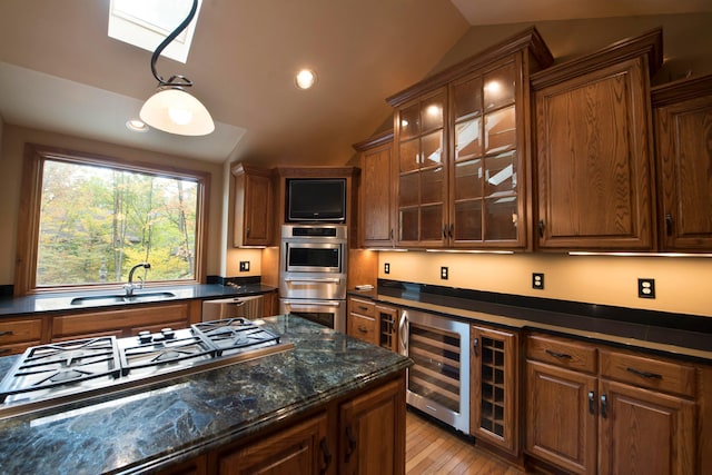 kitchen with sink, wine cooler, light hardwood / wood-style floors, lofted ceiling, and appliances with stainless steel finishes