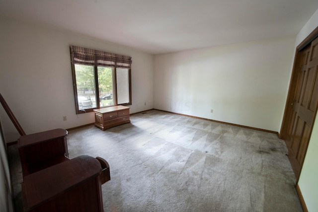 unfurnished room with light colored carpet