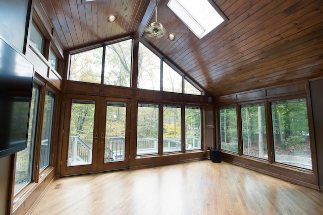 unfurnished sunroom with vaulted ceiling with skylight, wooden ceiling, and a wealth of natural light