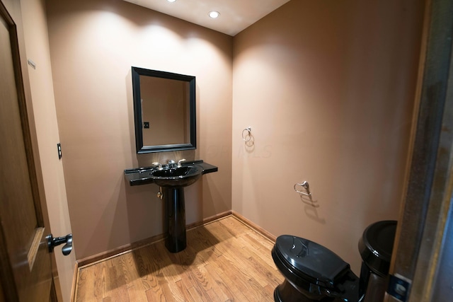 bathroom featuring hardwood / wood-style floors and toilet