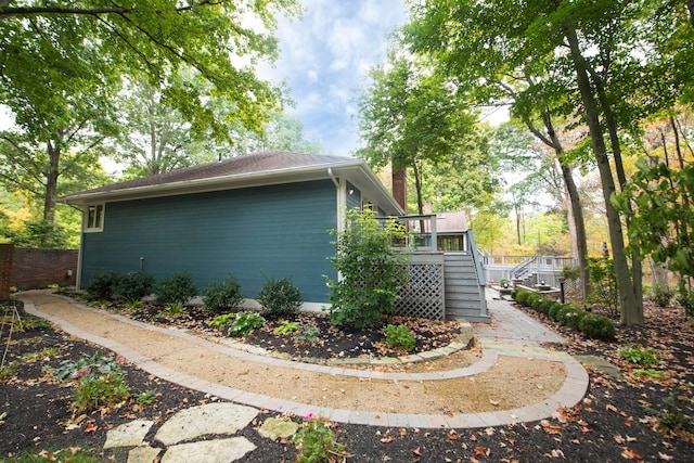 view of side of property with a wooden deck