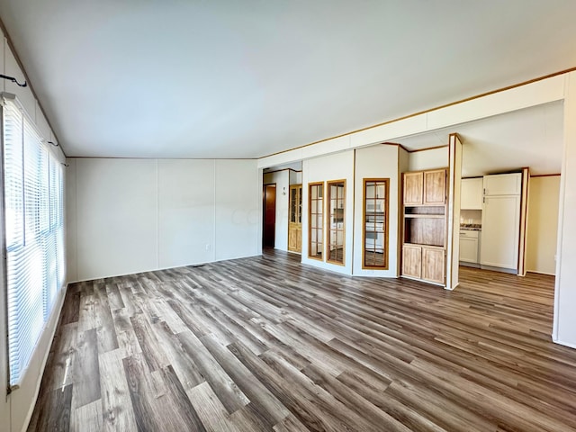 unfurnished living room with hardwood / wood-style flooring and vaulted ceiling