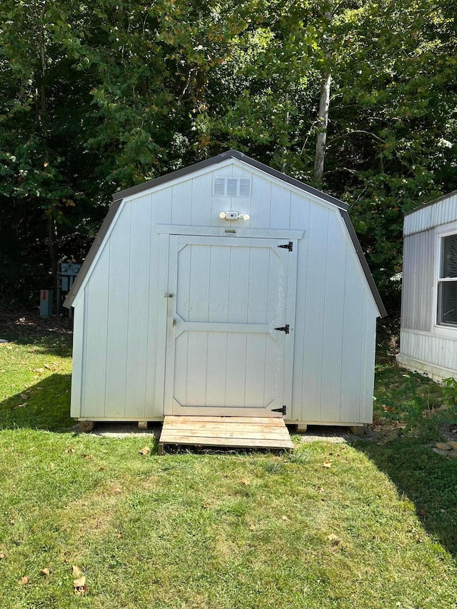 view of outbuilding featuring a lawn