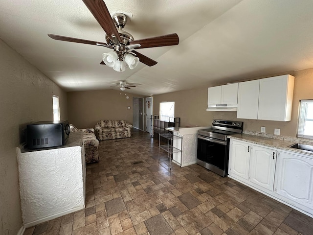 kitchen featuring white cabinets, sink, vaulted ceiling, and stainless steel electric range