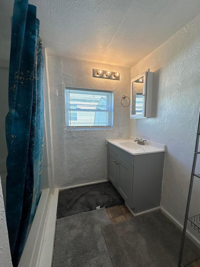 bathroom with vanity and a textured ceiling