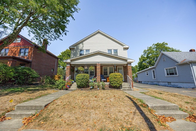 view of front of house with covered porch and a front yard