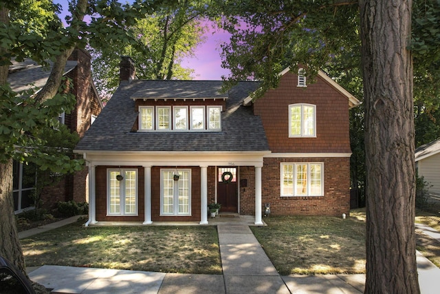 view of front of home featuring a porch and a yard