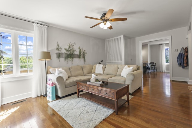 living room with ceiling fan and wood-type flooring