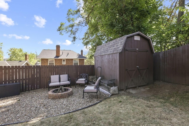 view of yard with a fire pit and a storage shed