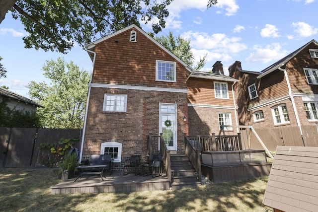 back of house featuring a yard and a deck