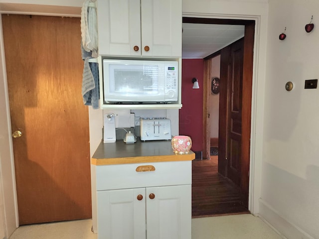 kitchen with white cabinets and light hardwood / wood-style floors