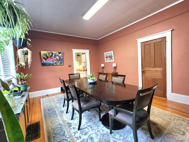 dining room featuring hardwood / wood-style flooring and ornamental molding