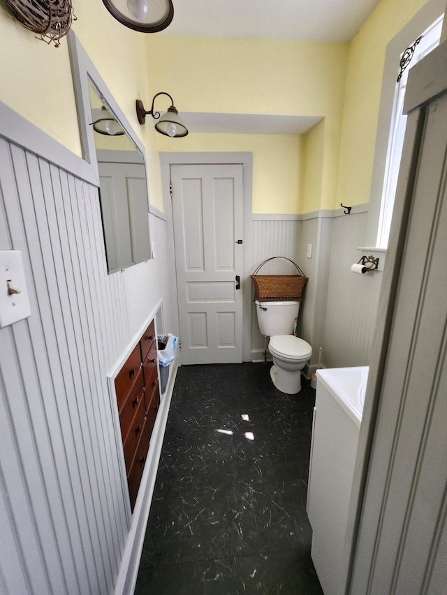 bathroom featuring vanity and toilet