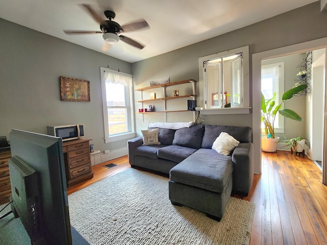 living room featuring hardwood / wood-style flooring and ceiling fan