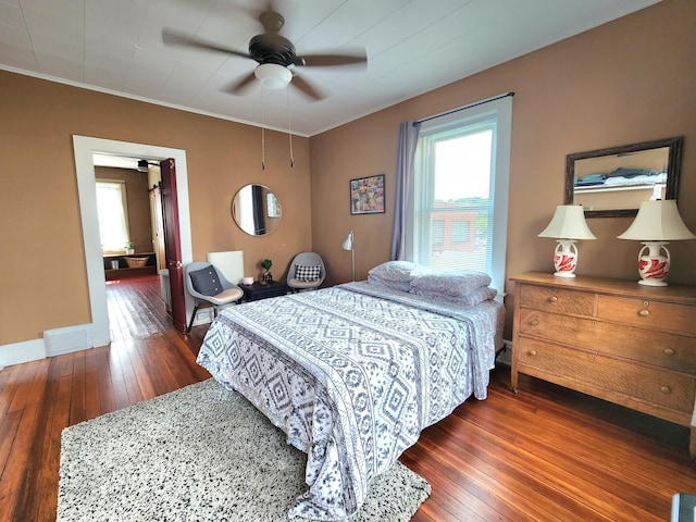 bedroom featuring ceiling fan, dark hardwood / wood-style flooring, and crown molding