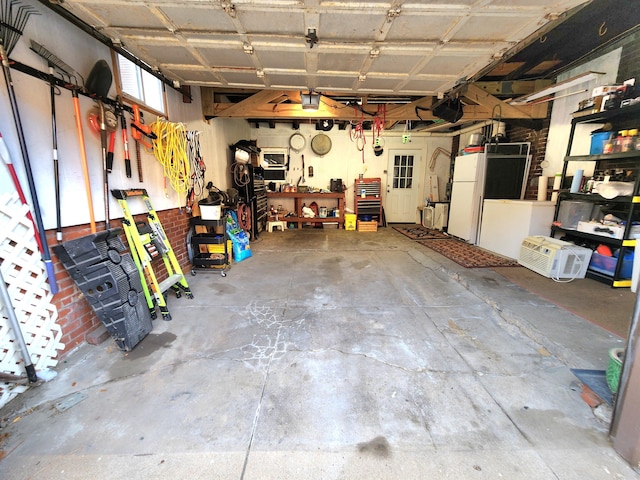 garage with a workshop area and white fridge