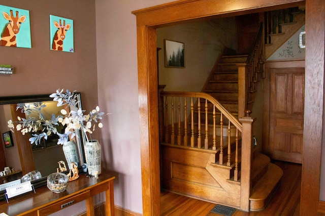 stairway featuring hardwood / wood-style flooring